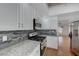 Updated kitchen with white cabinets, stainless steel appliances, and stylish tiled backsplash at 472 Staghorn Pass Ave, Las Vegas, NV 89183