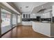 Modern kitchen with white cabinets, granite countertops, stainless steel appliances, and sliding glass doors to the patio at 472 Staghorn Pass Ave, Las Vegas, NV 89183