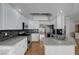 Spacious kitchen featuring white cabinets, granite countertops, and a stainless steel appliance package at 472 Staghorn Pass Ave, Las Vegas, NV 89183