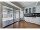 Eat in kitchen features ample cabinets, hardwood floors, and sliding glass doors to backyard patio at 472 Staghorn Pass Ave, Las Vegas, NV 89183