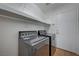 Functional laundry room with modern washer and dryer, shelving, and access to the outside at 472 Staghorn Pass Ave, Las Vegas, NV 89183
