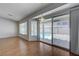 Bright living room features hardwood floors, large windows, and sliding glass door overlooking the pool at 472 Staghorn Pass Ave, Las Vegas, NV 89183