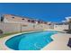 Backyard pool surrounded by a retaining wall and greenery at 472 Staghorn Pass Ave, Las Vegas, NV 89183