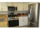 Well-lit kitchen featuring stainless steel appliances and granite countertops at 4821 Black Bear Rd # 104, Las Vegas, NV 89149