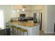 Open concept kitchen with stainless appliances, bar seating and granite countertops at 4821 Black Bear Rd # 104, Las Vegas, NV 89149