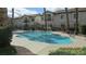 Community pool surrounded by well-maintained landscaping and nearby buildings at 4821 Black Bear Rd # 104, Las Vegas, NV 89149
