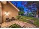 Cozy back patio featuring chairs, a manicured lawn, and serene waterfront views, ideal for relaxing outdoors at 5010 Crooked Stick Way, Las Vegas, NV 89113