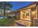 Home backyard featuring a grass yard, mature trees, and sliding glass doors at 5010 Crooked Stick Way, Las Vegas, NV 89113