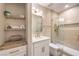 Well-lit bathroom featuring a vanity, a decorative shelf, and a glass shower at 5010 Crooked Stick Way, Las Vegas, NV 89113