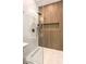Modern bathroom featuring a glass shower, rain shower head, and wood look tile at 5010 Crooked Stick Way, Las Vegas, NV 89113