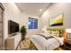 Bright bedroom showcasing a bed with colorful pillows and a view of the yard at 5010 Crooked Stick Way, Las Vegas, NV 89113