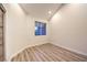 Bright bedroom showcasing hardwood floors, a window, and white walls at 5010 Crooked Stick Way, Las Vegas, NV 89113
