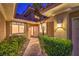 Inviting home entrance with lush landscaping and a well-lit walkway at 5010 Crooked Stick Way, Las Vegas, NV 89113