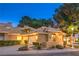 Charming home exterior showcasing manicured landscaping, a tile roof, and a welcoming driveway at 5010 Crooked Stick Way, Las Vegas, NV 89113