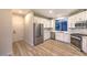 Modern kitchen with stainless steel appliances, white cabinets, and ample counter space at 5010 Crooked Stick Way, Las Vegas, NV 89113