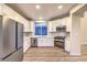 Modern kitchen with stainless steel appliances and white cabinets offers a clean, contemporary design at 5010 Crooked Stick Way, Las Vegas, NV 89113