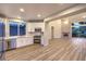 Modern kitchen with stainless steel appliances, white cabinets, and wood-look flooring at 5010 Crooked Stick Way, Las Vegas, NV 89113