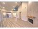Open living room featuring hardwood floors, a fireplace, and ample natural light at 5010 Crooked Stick Way, Las Vegas, NV 89113
