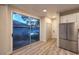 Living room with sliding door to exterior showing yard and view into the kitchen with stainless refrigerator at 5010 Crooked Stick Way, Las Vegas, NV 89113