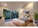 Staged primary bedroom features a large slider with backyard views, vaulted ceiling, and ensuite at 5010 Crooked Stick Way, Las Vegas, NV 89113