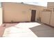 Cement backyard with a door, rock features, and a privacy fence at 5086 Mountain Vista St, Las Vegas, NV 89120