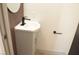 Modern half-bathroom featuring sink and mirror with dark wood trim at 5086 Mountain Vista St, Las Vegas, NV 89120