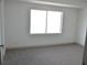 Bright bedroom features a large window and neutral carpet at 5086 Mountain Vista St, Las Vegas, NV 89120
