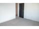 Bedroom features neutral carpet, black door, and closet at 5086 Mountain Vista St, Las Vegas, NV 89120