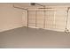 Spacious garage with a large white door and gray flooring at 5086 Mountain Vista St, Las Vegas, NV 89120