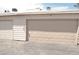 Exterior shot of the garage doors and siding at 5086 Mountain Vista St, Las Vegas, NV 89120