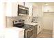 Modern kitchen with stainless steel appliances, white cabinets and stone backsplash at 5086 Mountain Vista St, Las Vegas, NV 89120