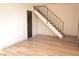 Open floor plan with staircase, wood floors, neutral walls and black trim at 5086 Mountain Vista St, Las Vegas, NV 89120