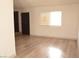 Open floor plan with wood floors, neutral walls and access to back rooms at 5086 Mountain Vista St, Las Vegas, NV 89120