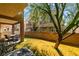 A lovely backyard featuring a covered patio, privacy wall, and small patch of lush grass, perfect for relaxation at 5509 Ante Up Ct # 102, Las Vegas, NV 89122