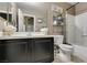 Well-lit bathroom with a tub-shower combo, commode, mirror and sink at 5509 Ante Up Ct # 102, Las Vegas, NV 89122