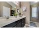 Bathroom featuring modern lighting, granite countertop, and custom cabinetry at 5509 Ante Up Ct # 102, Las Vegas, NV 89122