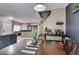 Open dining and living space featuring a dark accent wall, creating a seamless flow to the kitchen and staircase at 5509 Ante Up Ct # 102, Las Vegas, NV 89122