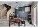 Dining space adjacent to staircase with dark accent wall, wooden table, and decorative accents at 5509 Ante Up Ct # 102, Las Vegas, NV 89122