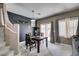 Cozy dining area with stylish decor, dark accent wall, and seamless transition to the carpeted staircase at 5509 Ante Up Ct # 102, Las Vegas, NV 89122