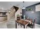 Dining table next to staircase and open kitchen, offering convenient access to kitchen appliances at 5509 Ante Up Ct # 102, Las Vegas, NV 89122