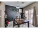 Inviting dining area featuring a dark accent wall, sliding glass doors and modern lighting fixture at 5509 Ante Up Ct # 102, Las Vegas, NV 89122