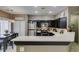 Cozy kitchen boasts stainless steel appliances, dark cabinetry, and adjacent dining area at 5509 Ante Up Ct # 102, Las Vegas, NV 89122