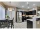 Bright kitchen features stainless steel refrigerator, dark cabinetry, and charming dining set at 5509 Ante Up Ct # 102, Las Vegas, NV 89122