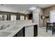 Open concept kitchen with an eat-in counter, white sink, and easy access to the dining area at 5509 Ante Up Ct # 102, Las Vegas, NV 89122
