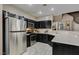 Well-equipped kitchen with stainless steel appliances, dark cabinets, and tiled floor at 5509 Ante Up Ct # 102, Las Vegas, NV 89122