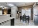 Kitchen with stainless steel refrigerator, dining area, and bright natural light at 5509 Ante Up Ct # 102, Las Vegas, NV 89122