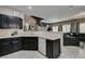 Spacious kitchen with dark cabinetry, modern appliances, and seamless access to living area at 5509 Ante Up Ct # 102, Las Vegas, NV 89122