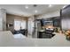 Modern kitchen with stainless steel appliances, dark cabinetry, and open view to dining area at 5509 Ante Up Ct # 102, Las Vegas, NV 89122