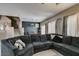 Bright living room featuring a large sectional, staircase, and contemporary decor at 5509 Ante Up Ct # 102, Las Vegas, NV 89122