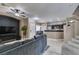 Open-concept living space with a large couch and views of the staircase and kitchen at 5509 Ante Up Ct # 102, Las Vegas, NV 89122
